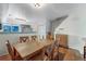 Inviting dining area with a wooden table, six chairs, and an open view of the kitchen at 12063 Monaco Ct, Brighton, CO 80602