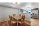 Dining area featuring a wooden table with six chairs, next to a modern kitchen setup at 12063 Monaco Ct, Brighton, CO 80602