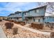 Charming blue townhomes with inviting front yards and beautiful stone landscaping at 12063 Monaco Ct, Brighton, CO 80602