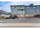 Blue townhome complex featuring convenient garage access and ample parking spaces at 12063 Monaco Ct, Brighton, CO 80602