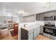 Modern kitchen with a view to a dining area and cozy living room at 12063 Monaco Ct, Brighton, CO 80602