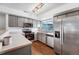 Well-lit kitchen featuring stainless steel appliances, sleek gray cabinets, and ample counter space at 12063 Monaco Ct, Brighton, CO 80602