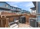 Private patio featuring outdoor seating, a grill, and a fenced-in yard at 12063 Monaco Ct, Brighton, CO 80602