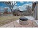 Spacious backyard featuring a fire pit, trees, and fence, creating a desirable outdoor space at 3290 S Holly St, Denver, CO 80222