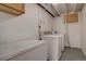 Basement laundry room features appliances, and painted floor, offering a functional space at 3290 S Holly St, Denver, CO 80222