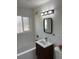 Stylish bathroom with a modern vanity, sleek mirror, and tiled shower-tub combination at 3290 S Holly St, Denver, CO 80222