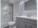 Bathroom boasts gray vanity and walk-in shower with glass doors at 3290 S Holly St, Denver, CO 80222