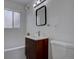 Modern bathroom with stylish vanity, new fixtures and tiled walls at 3290 S Holly St, Denver, CO 80222