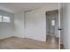 Clean bedroom featuring light hardwood floors and large sliding closet at 3290 S Holly St, Denver, CO 80222