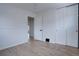 Well-lit bedroom with hardwood floors, closet and neutral paint, offering a clean and inviting space at 3290 S Holly St, Denver, CO 80222