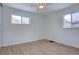 Bright bedroom with hardwood floors, neutral walls, and two windows, enhancing the spacious feel at 3290 S Holly St, Denver, CO 80222