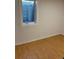 Room features small window and hardwood floors at 3290 S Holly St, Denver, CO 80222