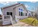 Rear view of house, showcasing patio and yard at 8363 Gladiola St, Arvada, CO 80005