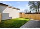 This cozy backyard features a well-maintained lawn and a modern-looking wall at 4236 Zuni St, Denver, CO 80211