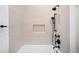 Elegant bathroom with a tiled shower featuring a sleek, modern rainfall shower head at 4236 Zuni St, Denver, CO 80211