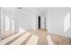 Minimalist bedroom with hardwood floors and white walls, providing a versatile and calming space at 4236 Zuni St, Denver, CO 80211