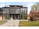 Modern home featuring a flat roof, dark metal siding, large windows, and minimalist landscaping at 4236 Zuni St, Denver, CO 80211
