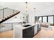 Bright, open kitchen featuring a large island, modern fixtures, and a seamless flow into the adjacent living area at 4236 Zuni St, Denver, CO 80211
