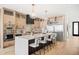 Spacious modern kitchen featuring a large island with seating, stainless steel appliances, and stylish lighting fixtures at 4236 Zuni St, Denver, CO 80211