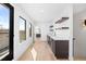 Bright open living area features a wet bar with sleek cabinets and a view of the exterior deck space at 4236 Zuni St, Denver, CO 80211