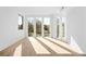 Bright living room filled with light from large windows, creating an open and airy atmosphere at 4236 Zuni St, Denver, CO 80211