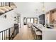 Open concept living with hardwood floors, modern kitchen, and a cozy seating area with a fireplace at 4236 Zuni St, Denver, CO 80211