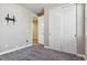 This bedroom boasts sliding closet doors, gray walls and carpet, and a wall-mounted TV at 1610 Cade Ave, Castle Rock, CO 80104