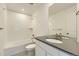 Modern bathroom featuring a tub, shower, sleek vanity, and a large mirror, perfect for a refreshing experience at 39867 Floyd St, Elizabeth, CO 80107