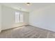 Clean, bright bedroom with a big window, plush carpet, neutral walls, and a simple modern design at 39867 Floyd St, Elizabeth, CO 80107