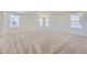 Spacious bedroom with plush carpet, neutral walls, and large windows offering plenty of natural light at 39867 Floyd St, Elizabeth, CO 80107