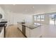 Modern kitchen featuring an island with stainless steel appliances, lots of natural light, and sleek countertops at 39867 Floyd St, Elizabeth, CO 80107
