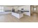 Beautiful kitchen with stainless steel appliances, an island with black countertops, and white cabinets at 39867 Floyd St, Elizabeth, CO 80107