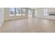 Bright living room with light wood floors, lots of windows, and white cabinets, perfect for relaxing or entertaining at 39867 Floyd St, Elizabeth, CO 80107