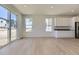 Inviting living room with lots of natural light from the windows and slider door, and white cabinets at 39867 Floyd St, Elizabeth, CO 80107