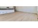 Bright living room with light wood floors and access to the kitchen island with black countertops at 39867 Floyd St, Elizabeth, CO 80107
