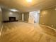 Finished basement with carpet, painted walls, brick fireplace, and access to the stairs at 2964 S Yates St, Denver, CO 80236