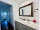 Bathroom with dual sinks, gray vanity, ornate mirror, and stylish fixtures at 2964 S Yates St, Denver, CO 80236