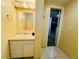 Bathroom featuring tile floors, a vanity, and a doorway at 2964 S Yates St, Denver, CO 80236