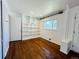 Flex room featuring hardwood floors, built-in bookshelves, and natural light at 2964 S Yates St, Denver, CO 80236
