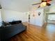 Bright living room with hardwood floors, a ceiling fan, and an open design at 2964 S Yates St, Denver, CO 80236