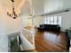 Open-concept living room featuring hardwood floors, white trim, and built in shelving at 2964 S Yates St, Denver, CO 80236