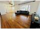 Bright living room with hardwood floors, large windows, and custom built-in shelving at 2964 S Yates St, Denver, CO 80236