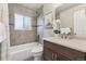 Well-maintained bathroom featuring a shower-tub combo and updated vanity at 970 S Canosa Ct, Denver, CO 80219