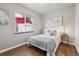 Bright bedroom with hardwood floors and a large window overlooking the backyard at 970 S Canosa Ct, Denver, CO 80219