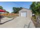 Detached one-car garage with a concrete driveway and ample parking space at 970 S Canosa Ct, Denver, CO 80219