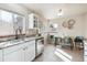 Eat-in kitchen featuring bright natural light, white cabinets and countertops, and stainless appliances at 970 S Canosa Ct, Denver, CO 80219