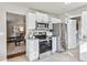 Modern kitchen with stainless steel appliances, white cabinets, and an open layout to the living room at 970 S Canosa Ct, Denver, CO 80219