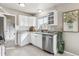 Bright and modern kitchen featuring white cabinets, stainless steel appliances, and granite countertops at 970 S Canosa Ct, Denver, CO 80219