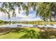 Scenic view of the lake with benches, and shady trees on a sunny day at 970 S Canosa Ct, Denver, CO 80219