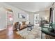 Open living room features hardwood floors, stylish seating, and an open doorway to the kitchen at 970 S Canosa Ct, Denver, CO 80219
